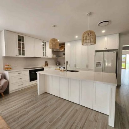 white kitchen design with unique overhead lights