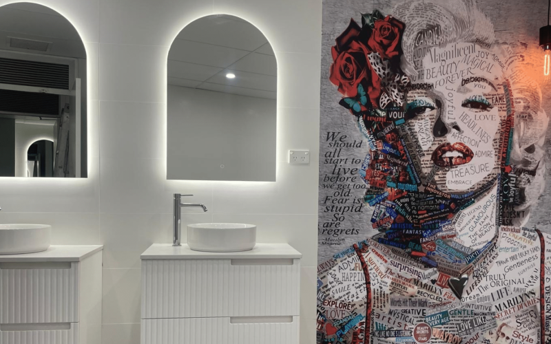 bathroom with two large mirrors and a portrait of marilyn monroe