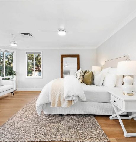 white bedroom with large bed and pillows